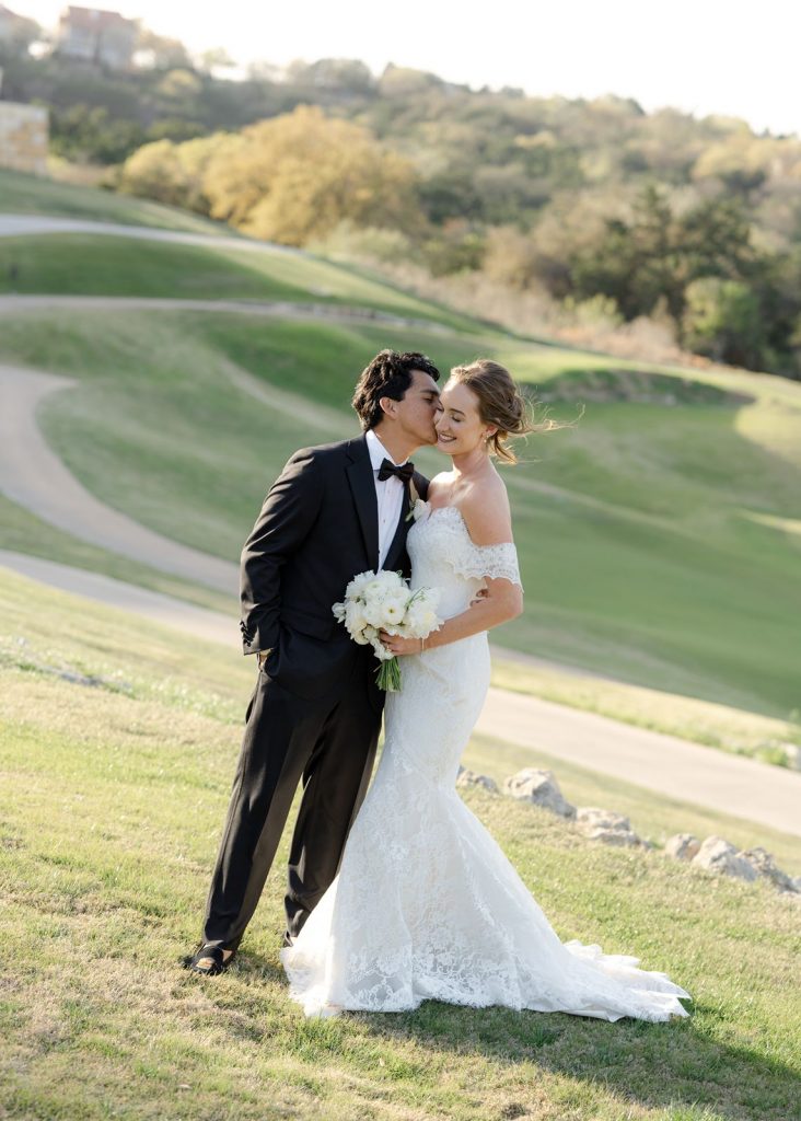 Bride, groom and rolling hill country at Omni Barton Creek, flowered by Flora Fetish