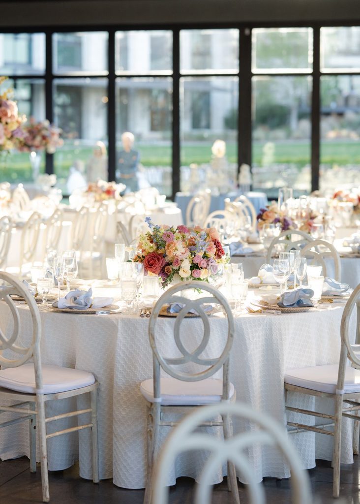 Wedding reception at the Hill Country Pavilion at Omni Barton Creek, featuring arrangements made by Austin, Texas Florist, Flora Fetish