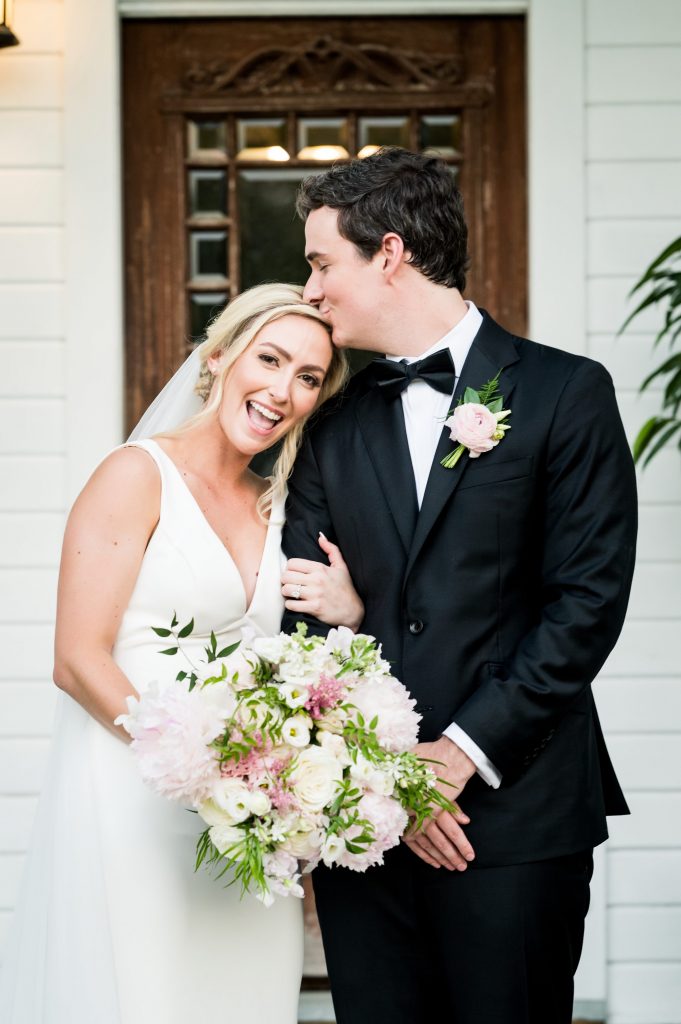 Newlyweds posing after their Barr Mansion wedding ceremony.
