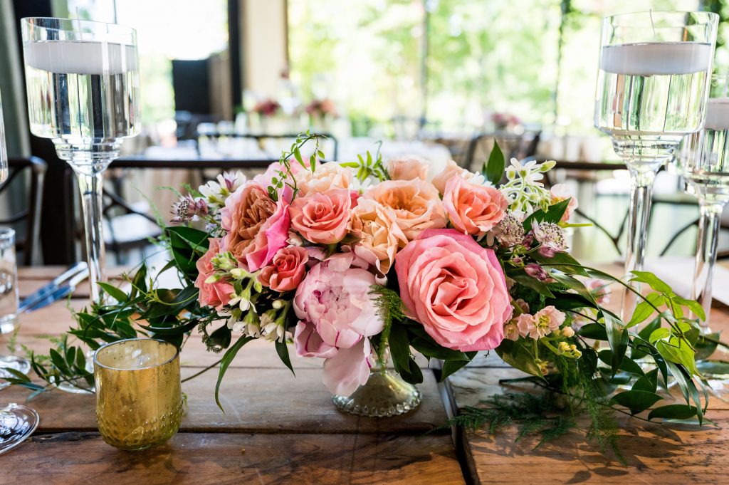 Pink and peach floral centerpiece at Barr Mansion wedding reception.