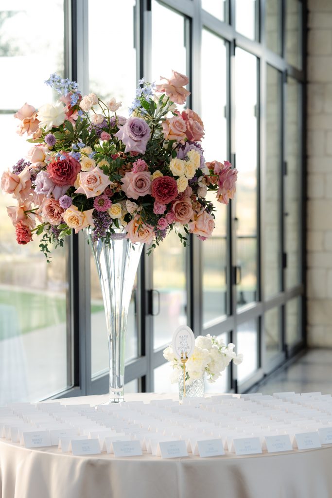 A hill country wedding at Omni Barton Creek Resort in the pavilion with tall colorful florals. natural light and lots of details in Austin, Texas 